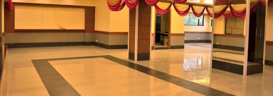 View of banquet hall called The Durbar with polished flooring and ample space for events - Max Hotel Prayagraj.