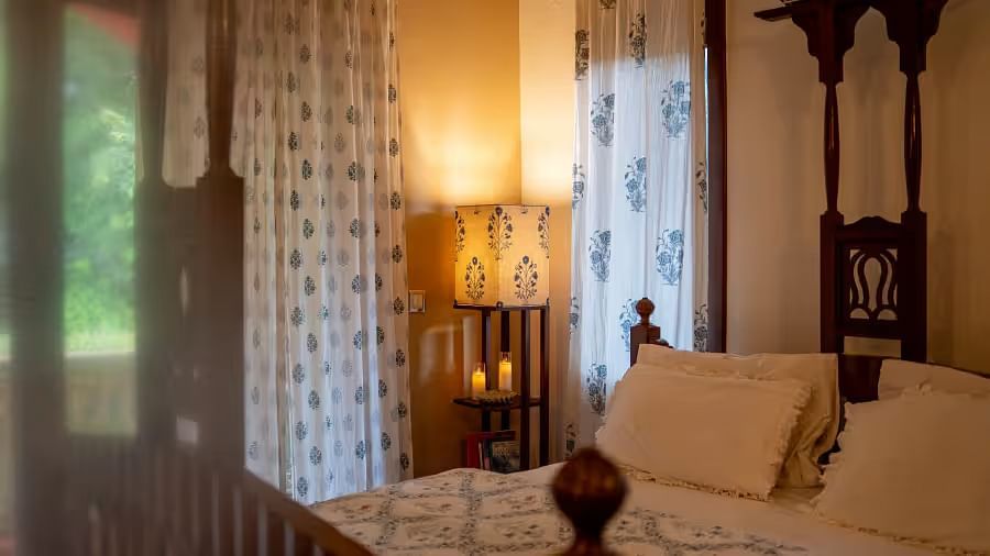 Image displaying a double bed and a lamp next to it in the corner