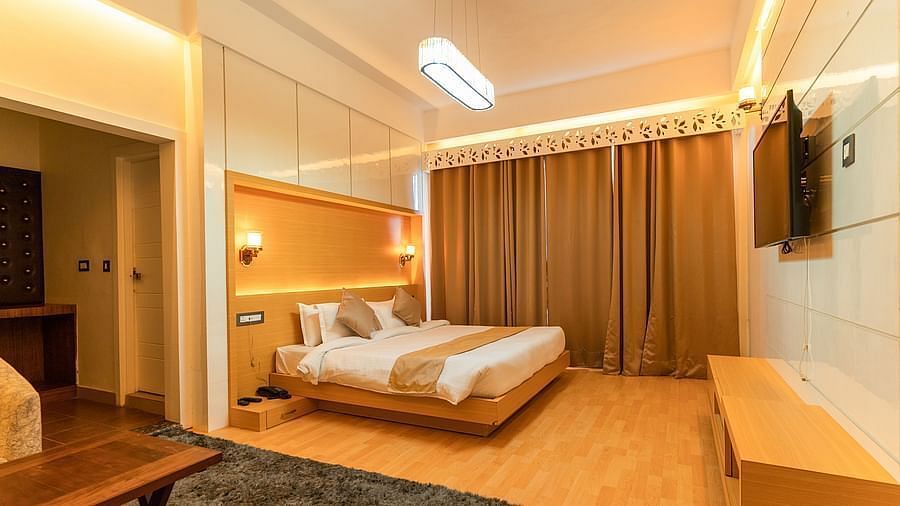 A bedroom with a bed, a desk, and a television, demonstrating a comfortable living space