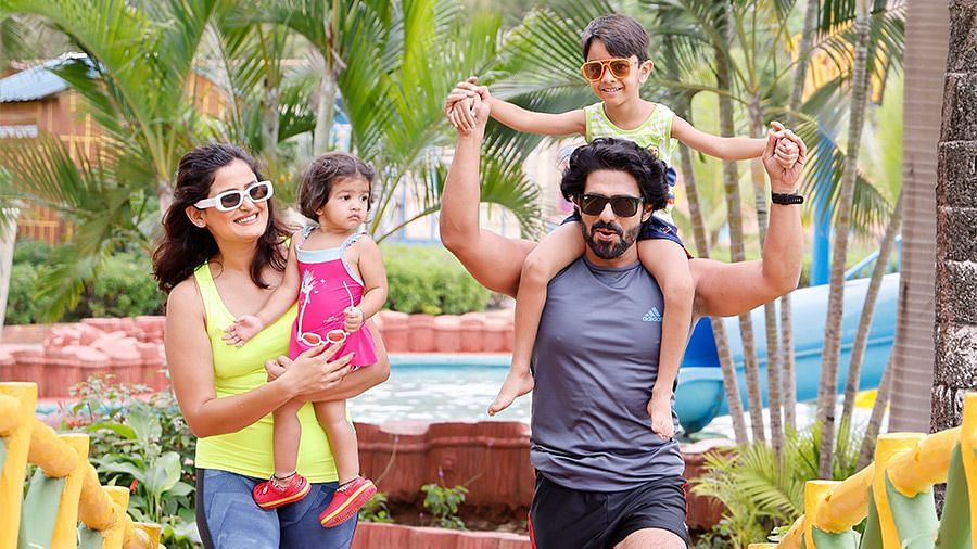 An overview of a family of four where the children are being held by their parents in Diamond Parks, Pune.