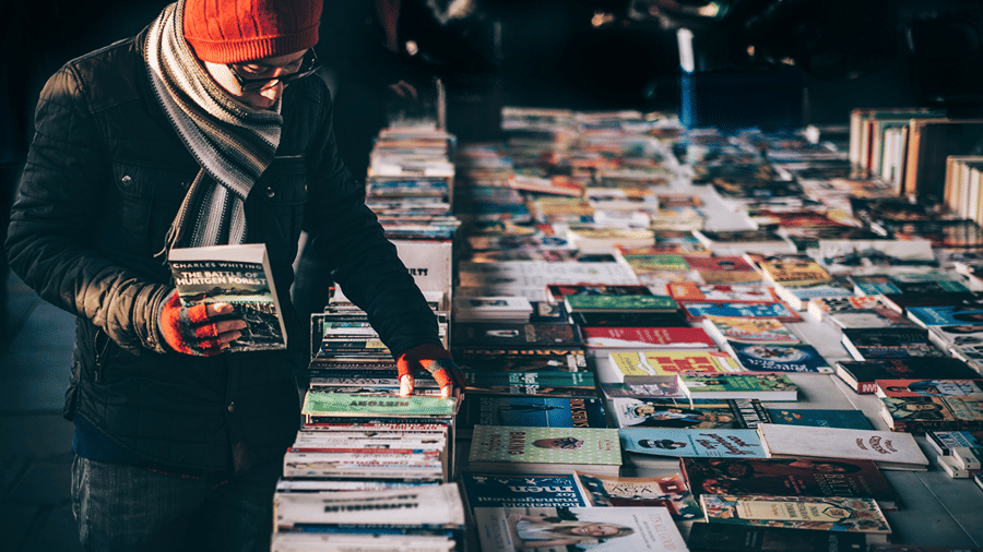 books stacked on each other and kept on racks