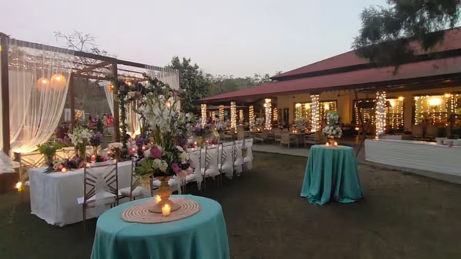  An image of a outdoor banquet hall with chairs and a stage decorated for destination wedding halls - Riverview Retreat, Corbett