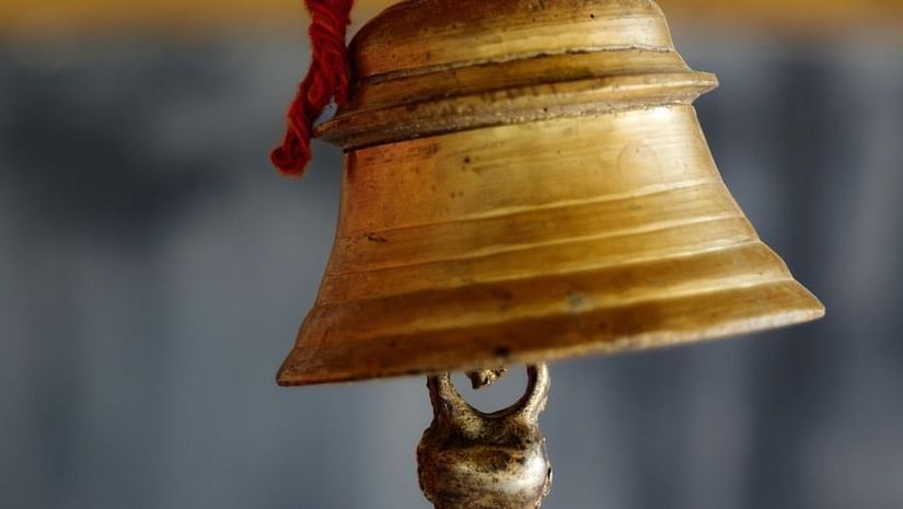 A close up of a bell being strung.