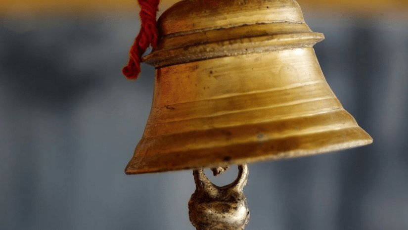A close up of a bell being strung.