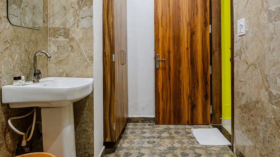 A bathroom with a pedestal sink, and a wall mirror - Lime Tree Hotels & Banquet, Vrindavan 
