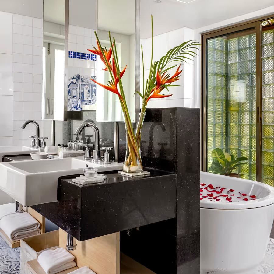 overview of the bathroom inside the Presidential Villa with a bathtub behind the counter - Caravela Beach Resort Goa