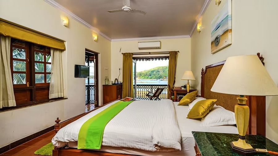 A double bed lamp on the marble side table and entrance to olivia room at neemrana s three waters zqqaq9