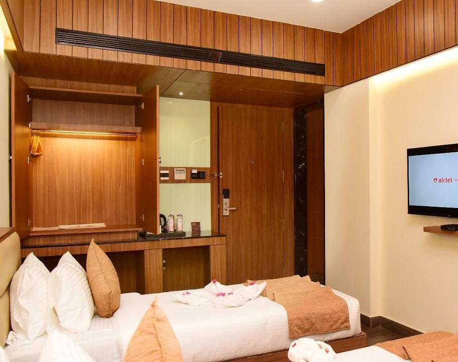 Twin beds with an LCD Television at TGI Felicity, Bangalore