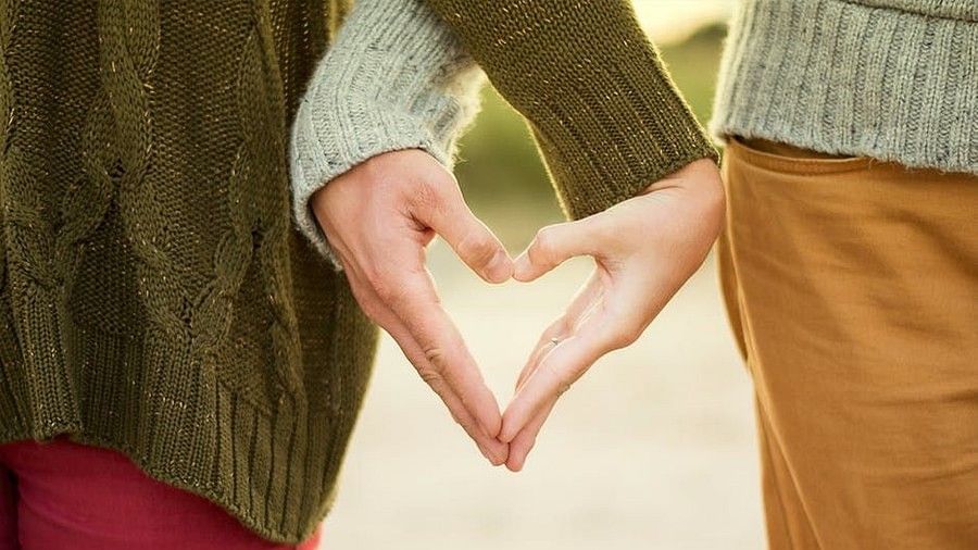 Couples making a heart shape and by hands