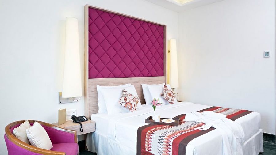 Bed, pillows and bedside sofa of our Superior Rooms in Jaipur 