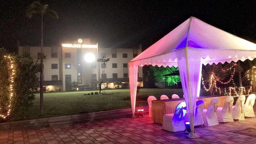 a canopy with seats under it and Wedlock Greens Hotel Resorts Dhanbad in the background