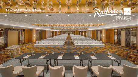 A stylish conference hall at Radisson Blu GRT Chennai with elegant lighting, rows of seating and modern decor showcasing the Chennai’s Signature Meetings offer.