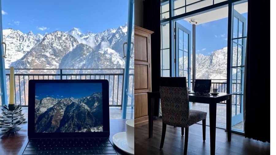 A room with sitting area and outdoor view which gives a sneak peak of the mountains  | Faraway Cottages, Auli