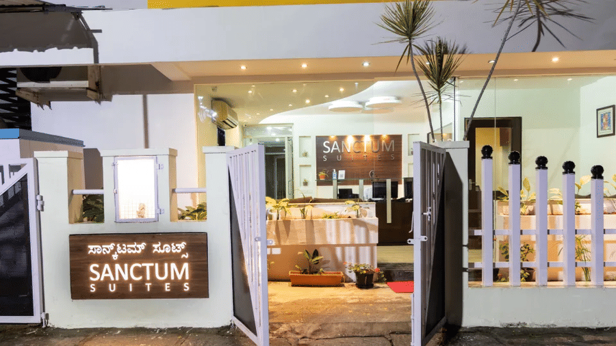Welcoming entrance gate of Sanctum Suites Domlur Bangalore with signage and landscaping