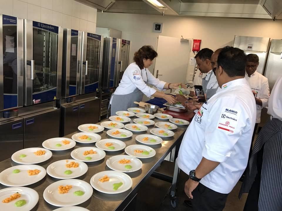 Chef plating a bunch of plates on the table.