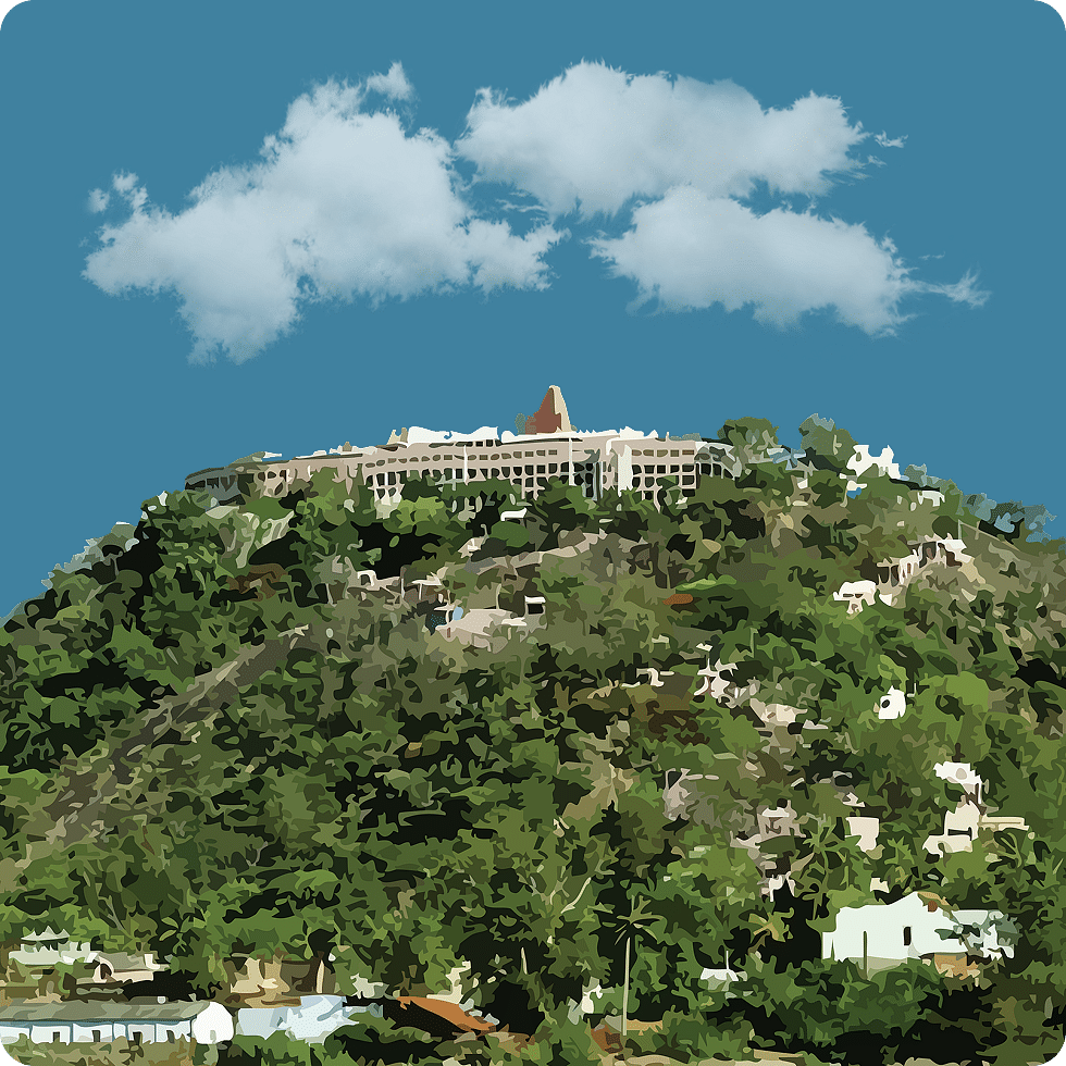 A scenic hilltop temple nestled in lush greenery, offering a panoramic view of the surrounding landscape.