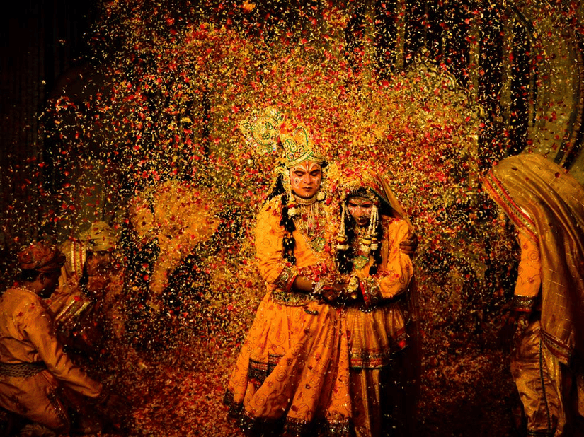 A colorful and dynamic scene of Holi celebrations, with people covered in vibrant yellow powder.