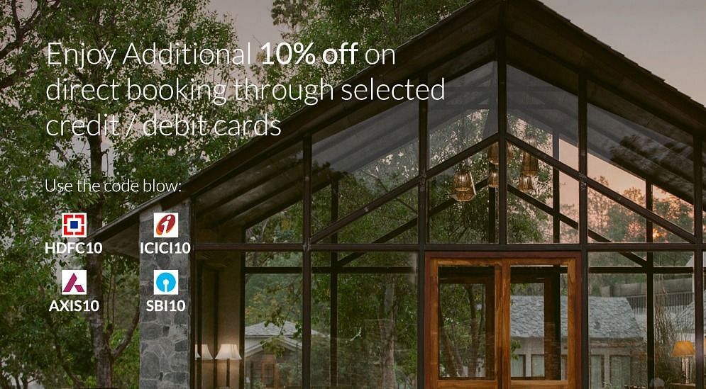 Glass-front resort at sunset, offering extra 10% off with select bank cards and promo codes.