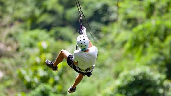 A person joyfully experiencing the Flying-fox activity at our resort in Gokarna - Stone Wood Nature Resort, Gokarna