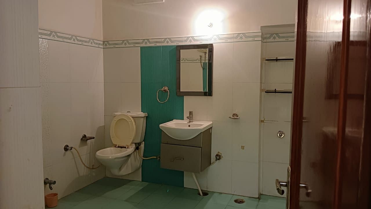 A modern bathroom with a modern white sink and shower area - Motel Divine International, Roorkee