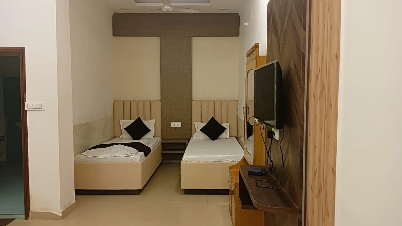 An image of single beds in a suite in Roorkee - Motel Divine International, Roorkee