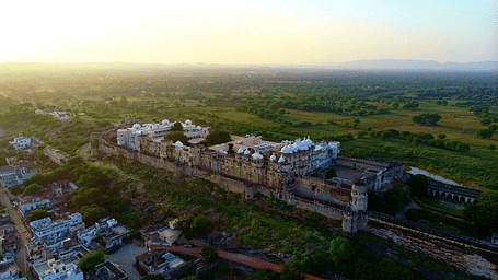 A drone shot of Sardargarh Heritage Fort seen during a serene sunrise