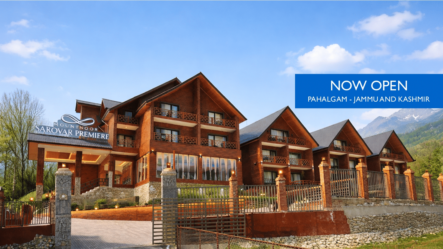 Web banner of Mountnoor Sarovar Premiere, Pahalgam, showcasing the picturesque facade and surroundings of the property.