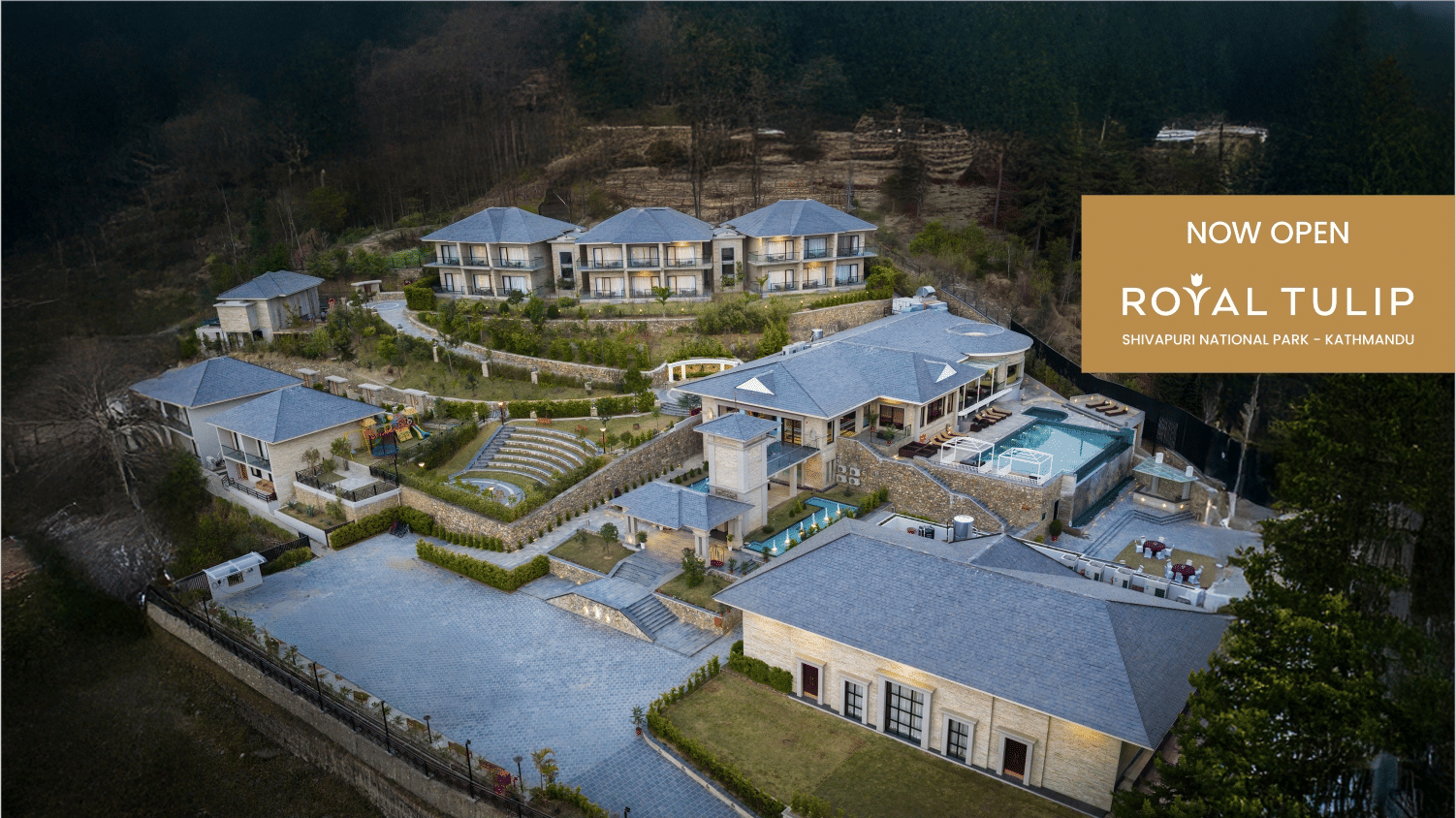 A web banner of Royal Tulip, Kathmandu - Shivapuri National Park, showcasing an aerial view of the resort's expanse surrounded by dense forest.