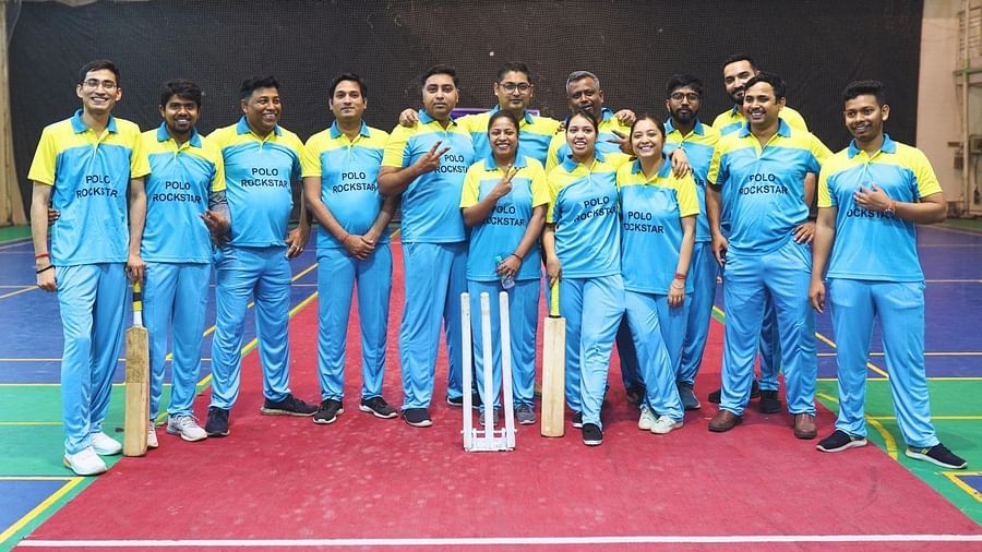 A group of employees in yellow blue jersey gathered together to take a picture - Polo Towers
