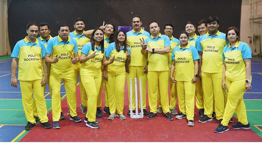 A group of employees in yellow jersey gathered together to take a picture - Polo Towers