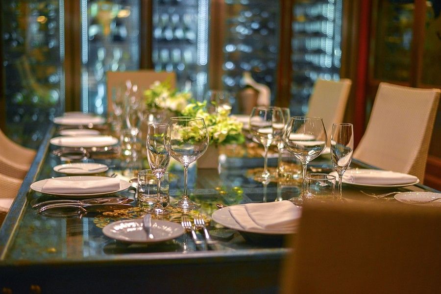 alt-text a close up image of the dining table with well arranged crockery and glassware - Maikhao Dream Villa Resort & Spa, Phuket