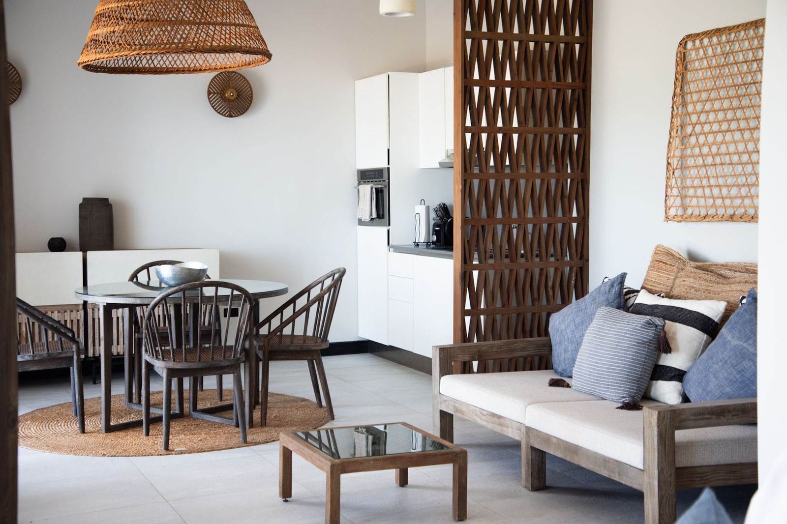 A living area with a sofa, a tea table and a dining area at Tamarind Hills Resort and Villas, Antigua.