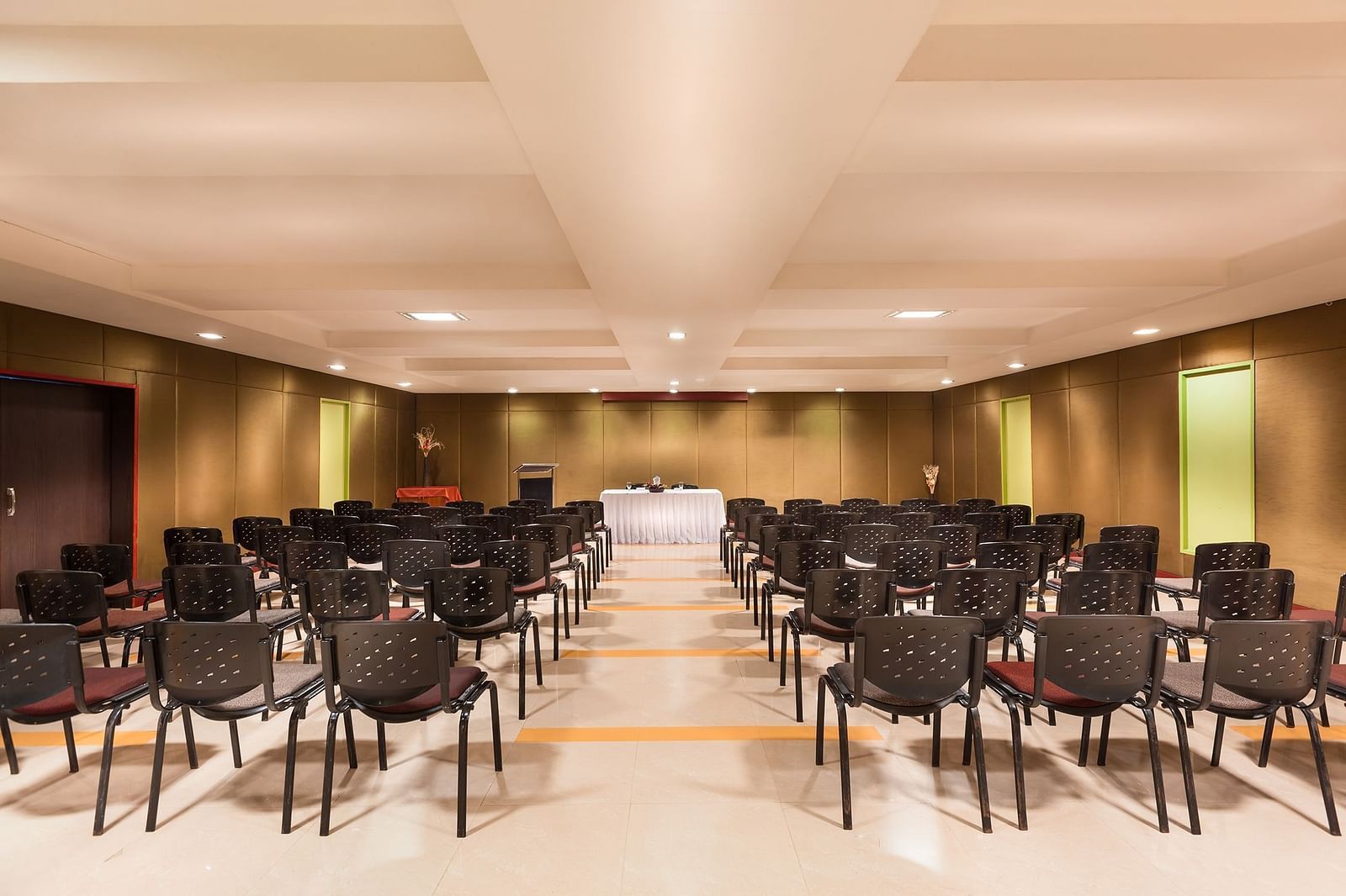 A view of the banquet hall of with black chairs at Regency Tuticorin by GRT Hotels.