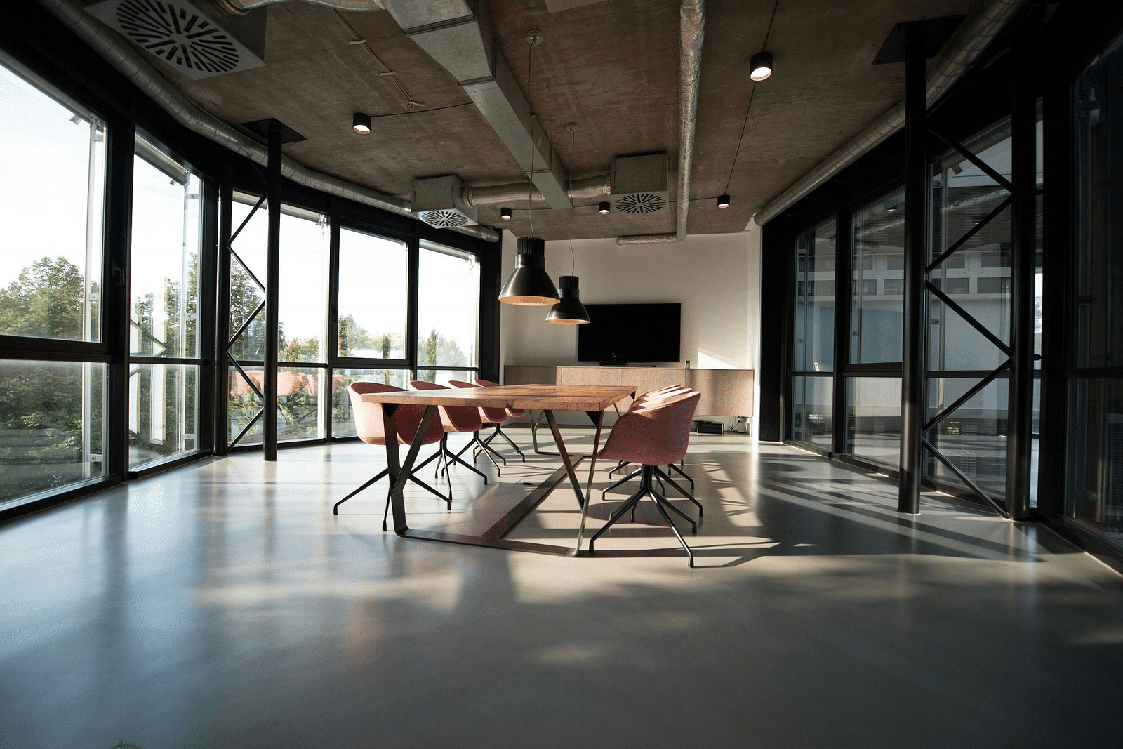 An overview of an empty conference room with floor to ceiling windows at Rhythm Gurugram