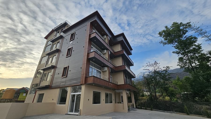 Facade of A’otel by Clarks Inn Palampur surrounded by trees
