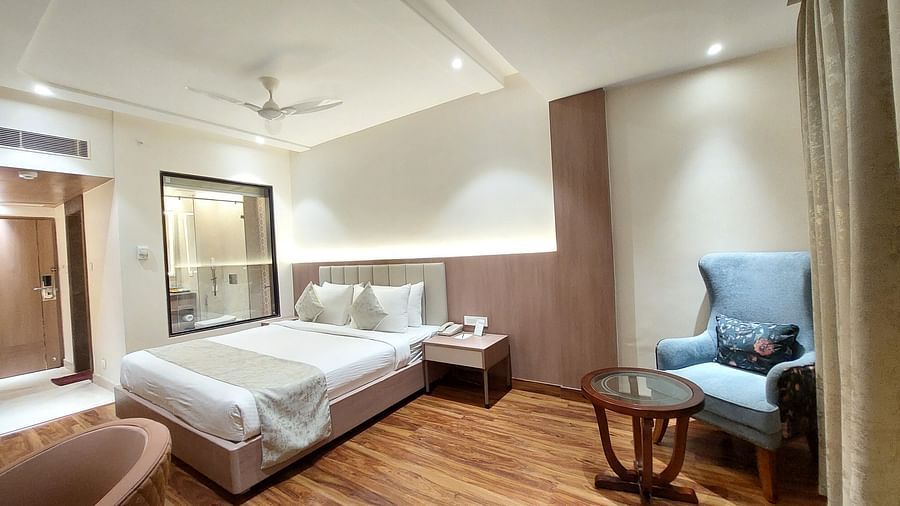  Spacious twin room at Hotel City Inn, Varanasi, with plush bedding, elegant seating, and warm ambient lighting.