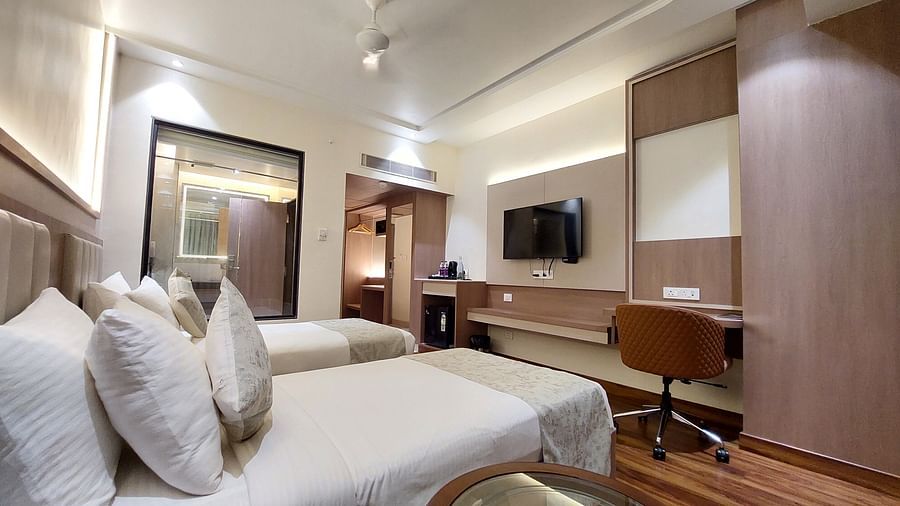 Modern guest room at Hotel City Inn, Varanasi, with large bed, work desk, flat-screen TV, and comfortable lighting.