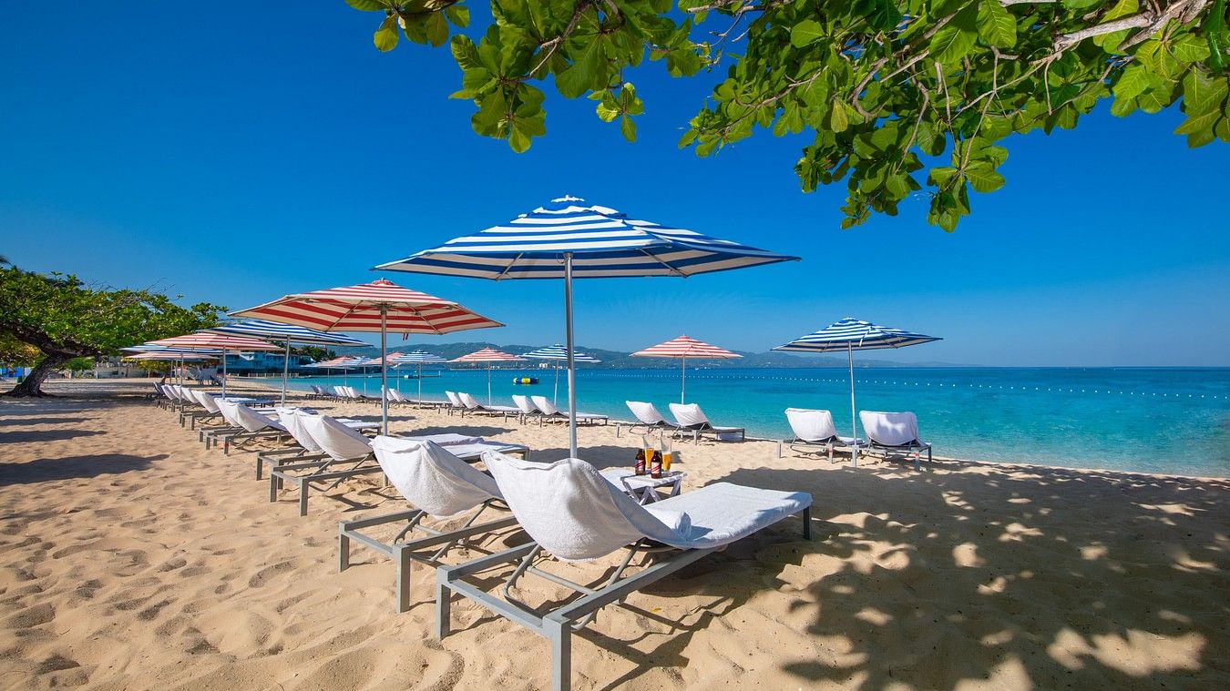 An image of a beach with sun loungers and chairs for relaxation - S Hotel Montego Bay, Jamaica