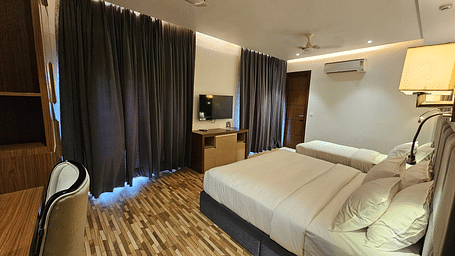 a family executive room at Eminence The Corbett with curtains drawn over the windows