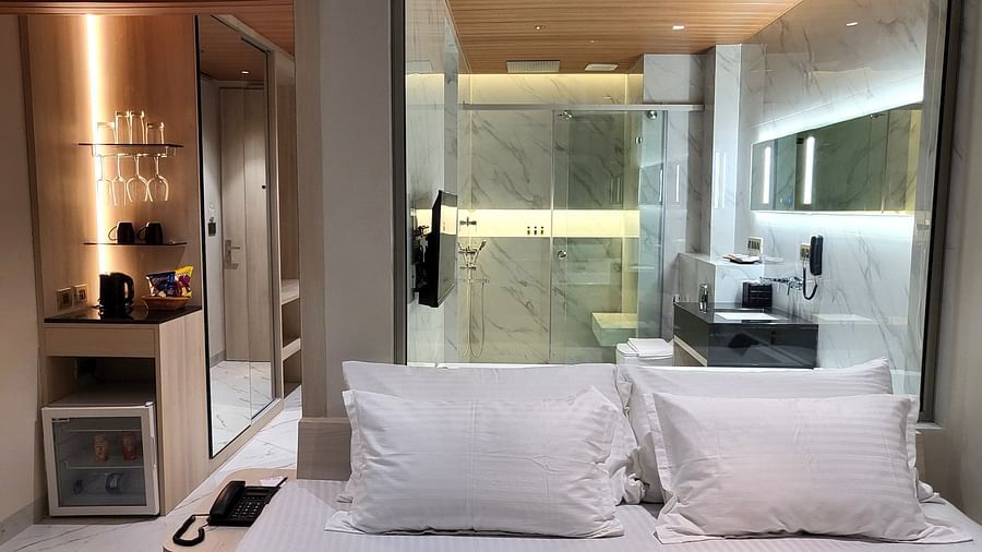 Image of four pillows kept on a bed along with a washroom in the background in 6ix sea view room with Jacuzzi at 6ix Seashore Hotel, Port Blair