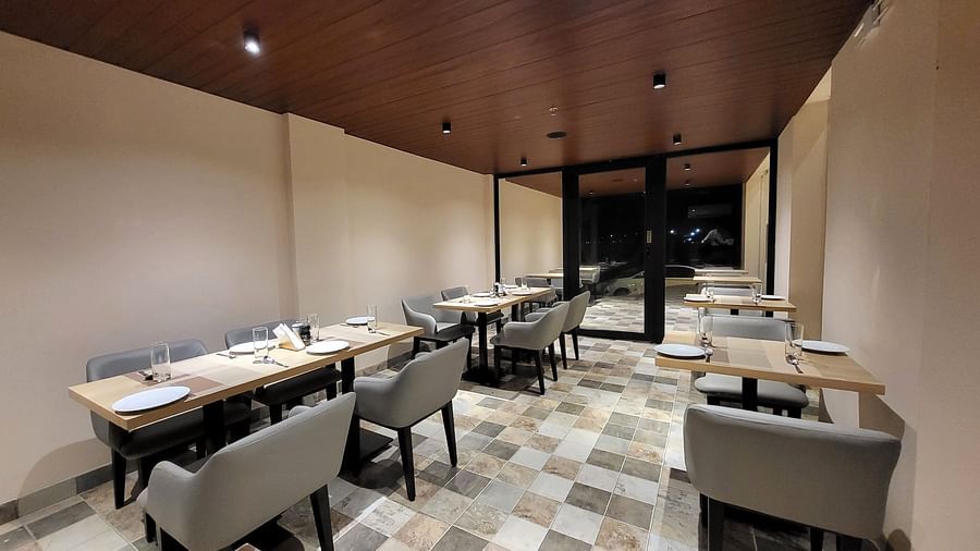 Inside the in 6ix Sea View Restaurant at 6ix Seashore Hotel, Port Blair with chairs and tables are arranged neatly