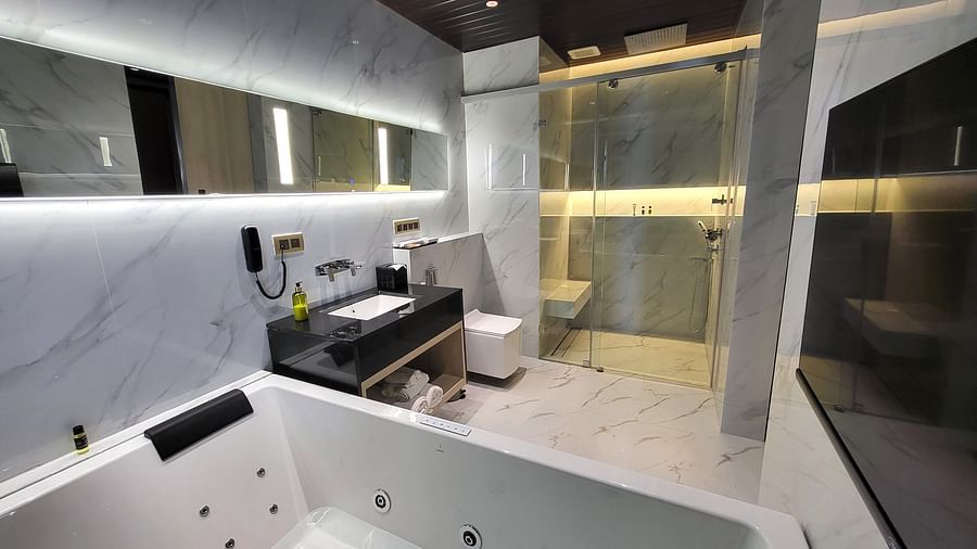 Jacuzzi and a sink in the washroom of Double 6ix Sea View with Jacuzzi Double Sized Bed at 6ix Seashore Hotel, Port Blair