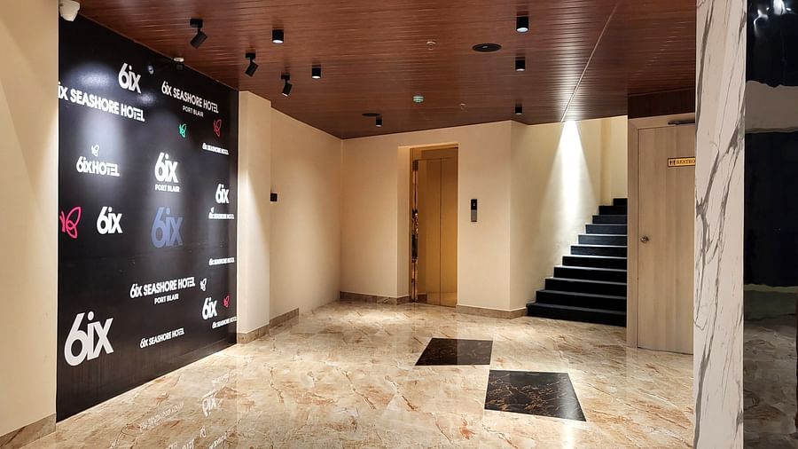 The Lobby at 6ix Seashore Hotel, Port Blair with a wooden door and a black staircase