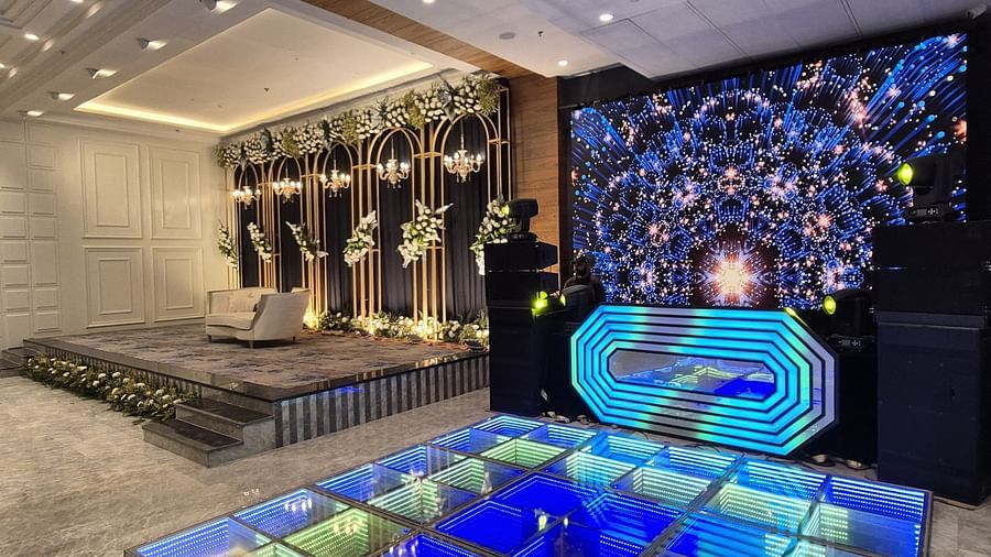 Luxurious indoor water feature with blue lighting and floral accents at Ramada by Wyndham Sonipat Murthal