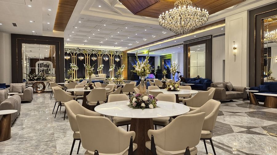 Elegant event space with chandelier lighting and neutral-toned seating, showcasing a sophisticated setting at Ramada by Wyndham Sonipat Murthal