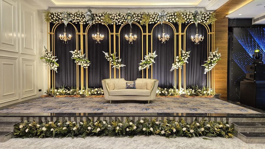 Decorative wedding stage setup with floral arrangements and elegant backdrop at Ramada by Wyndham Sonipat Murthal