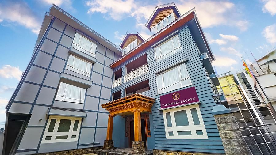 Facade image of our hotel taken from a lower angle with a cloudy blue sky in the background - Yashshree Lachen