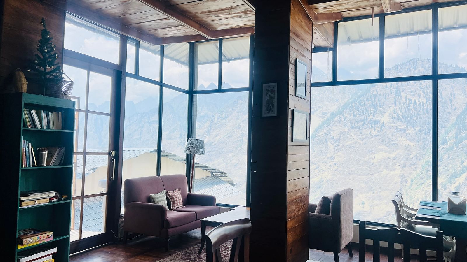 Sophisticated sitting area in a mountain retreat with expansive windows and nature views  | Faraway Cottages, Auli