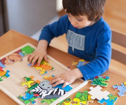 A kid playing with a puzzle set - Kaldan Samudra Palace