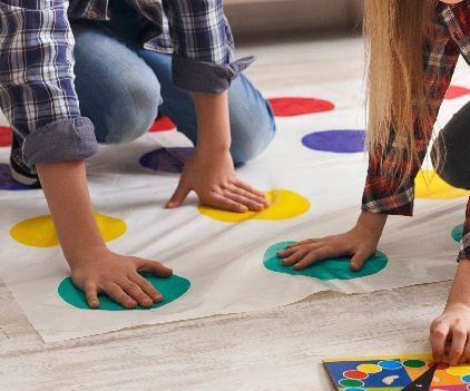 Two kids enjoying a game of twister - Kaldan Samudra Palace, one of the top 5 Star Resorts with Game Activities